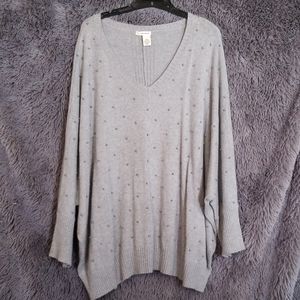 Sweater with gray pearls on it.
